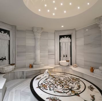 Warm stone benches around with wash basins in Befine Spa at Titanic Business Kartal
