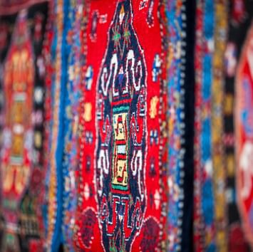 Close-up of a red color patterned rug carpet in a shop near Titanic Business Kartal