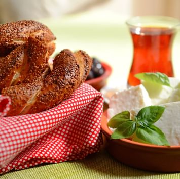 Close-up of bread and cheese served with a cup of tea in a restaurant near Titanic Business Kartal