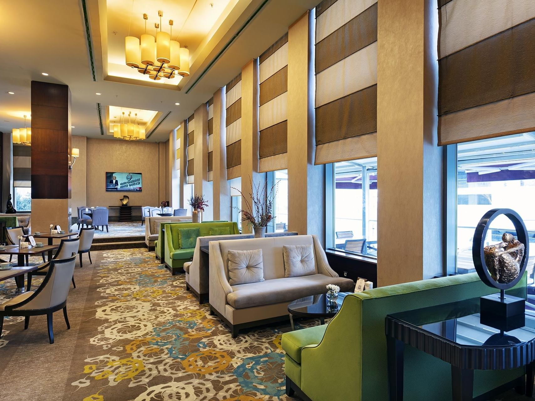 Dining tables arranged with cozy loungers in Titanic Coffee at Titanic Business Kartal