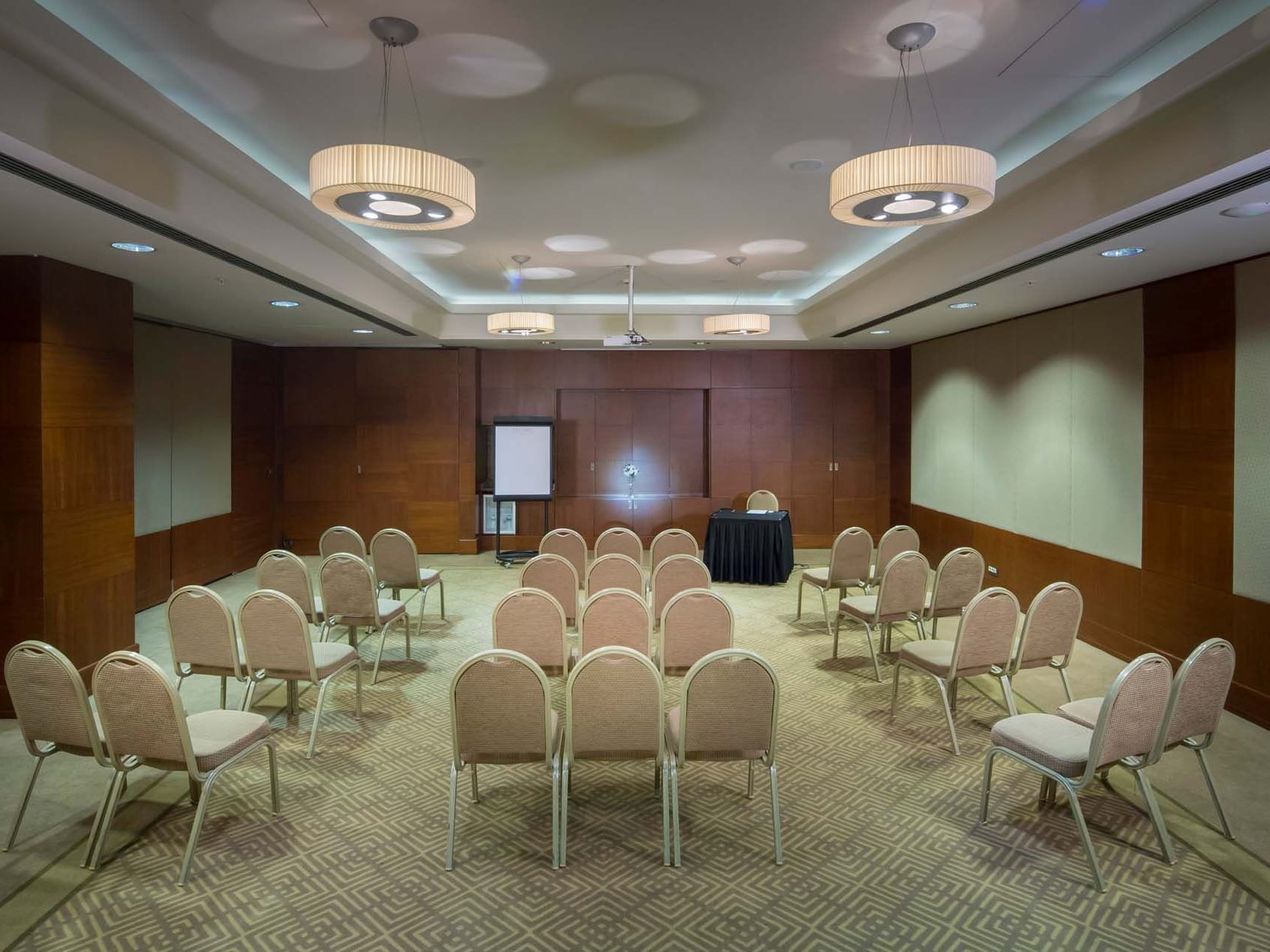 Conference room with chairs and a podium in the center at Titanic Business Kartal.
