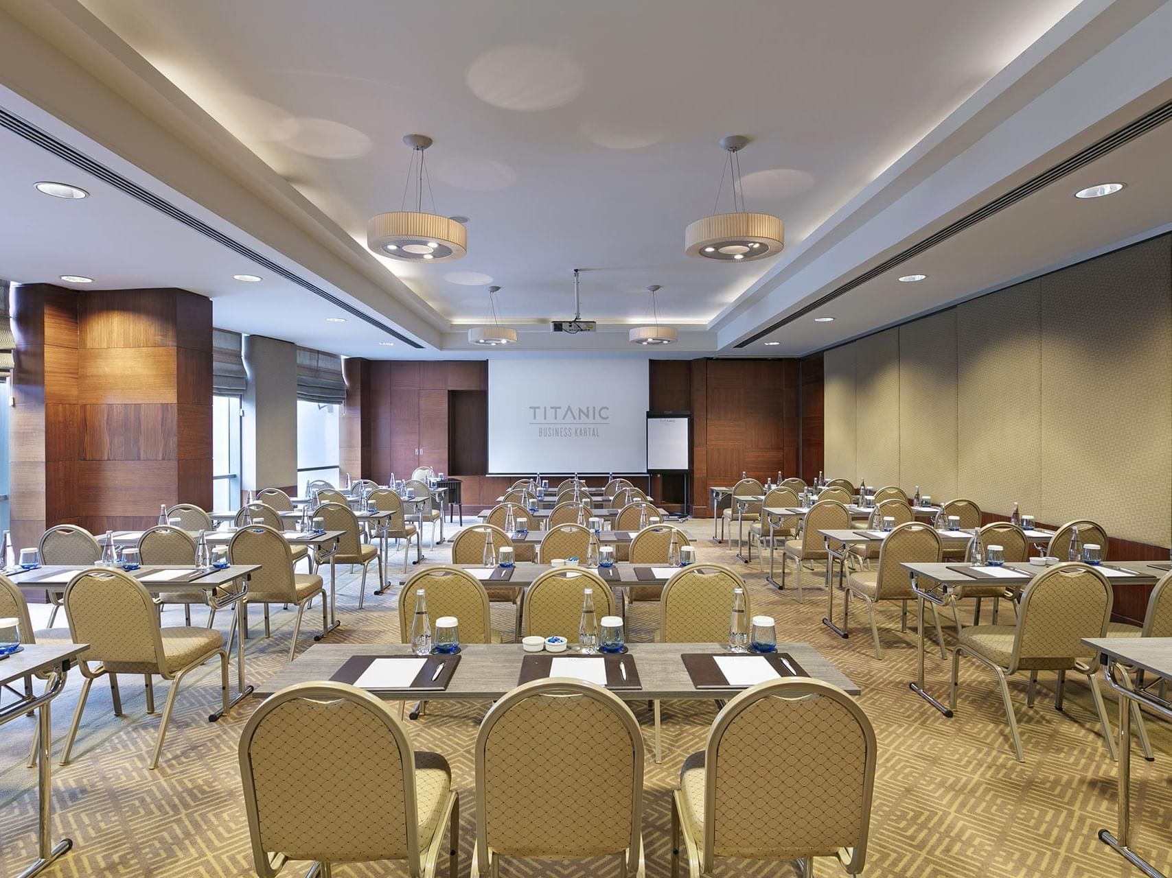 Classroom-typed meeting room arranged with tables and chairs in Azor at Titanic Business Kartal