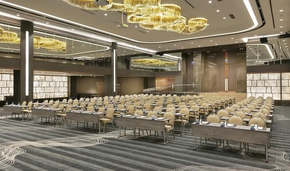 Large conference room setup with numerous tables and chairs at Titanic Business Kartal in Istanbul.