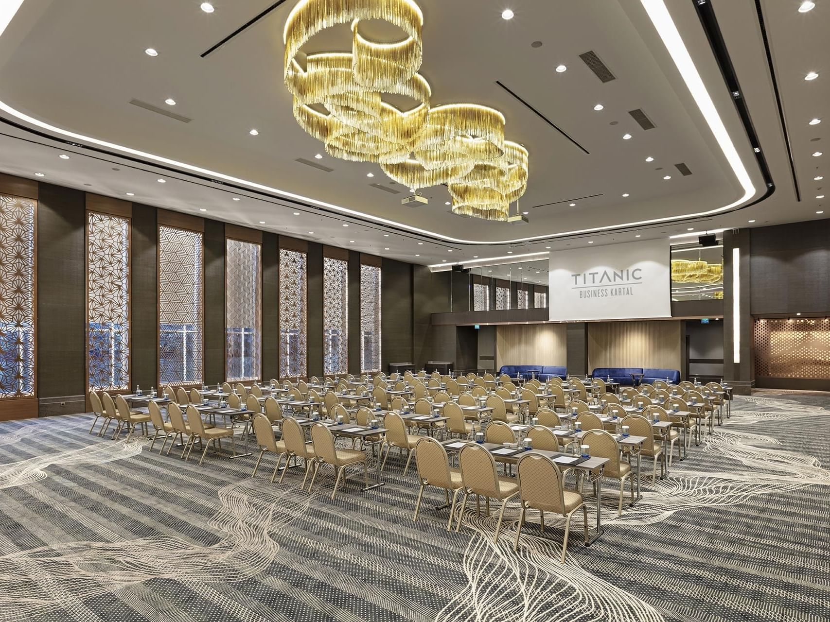 A large meeting room set up for an event at Titanic Business Kartal.