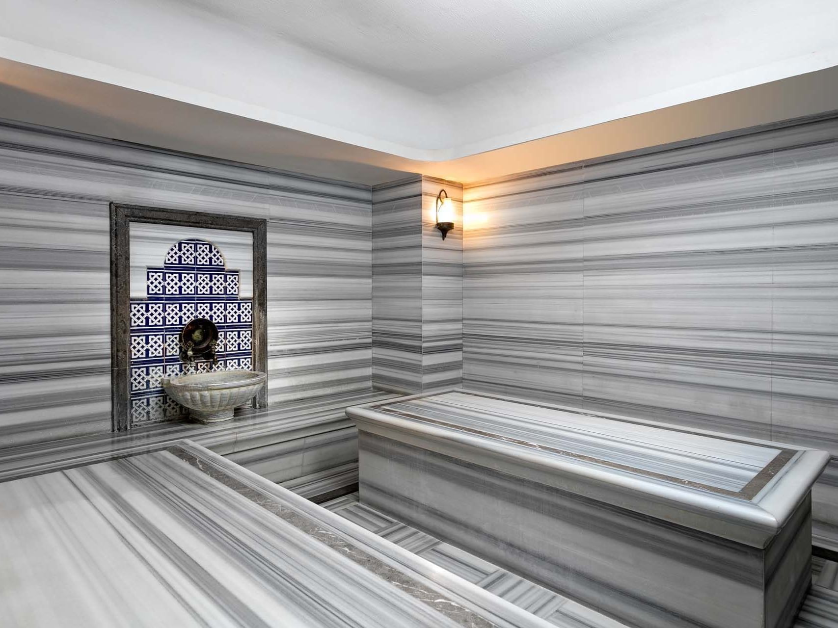 Sauna with decorative wall and bench at Titanic Business Kartal.