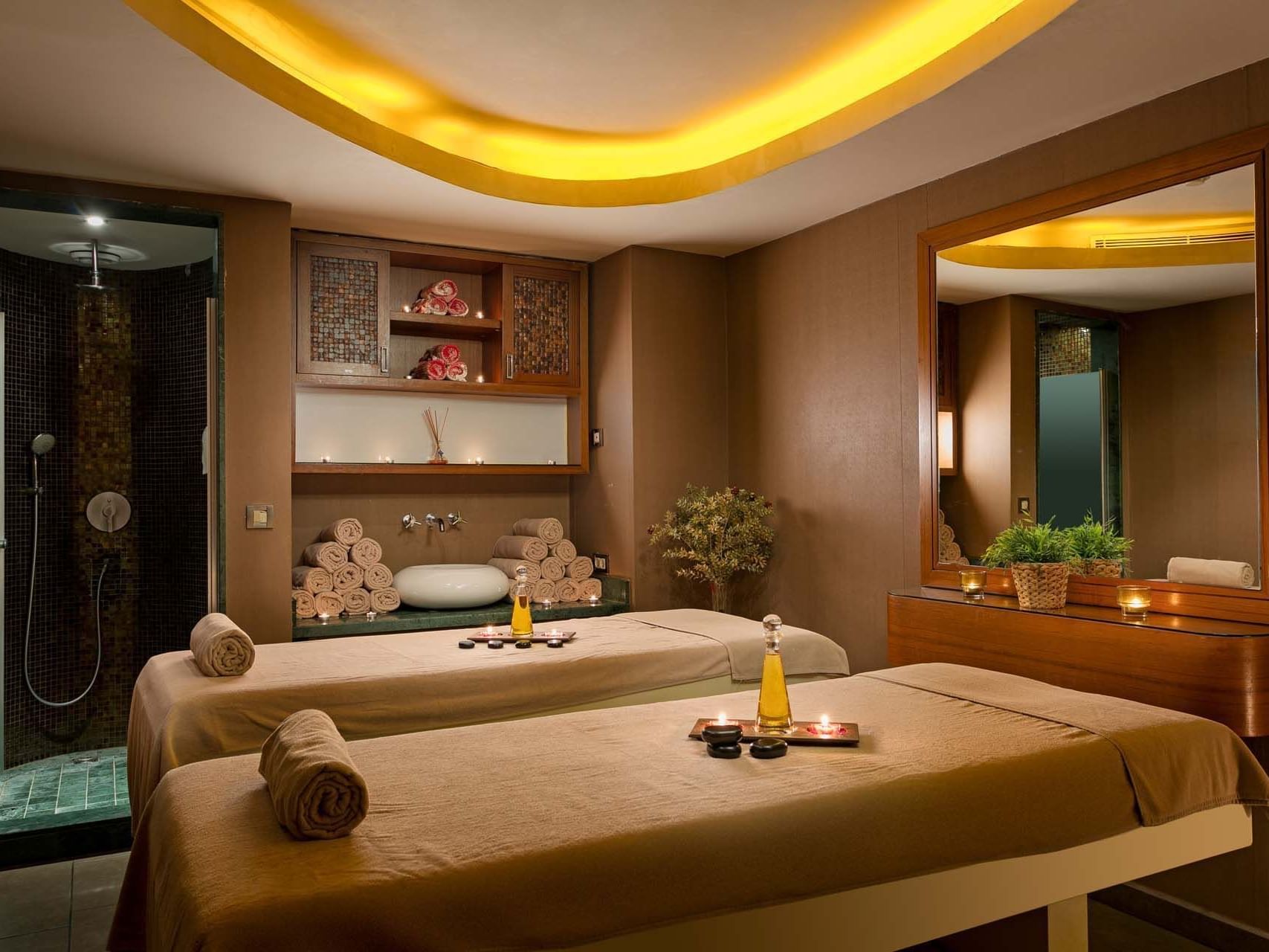 Two massage beds with candles in a relaxing spa setting at Titanic Business Kartal.