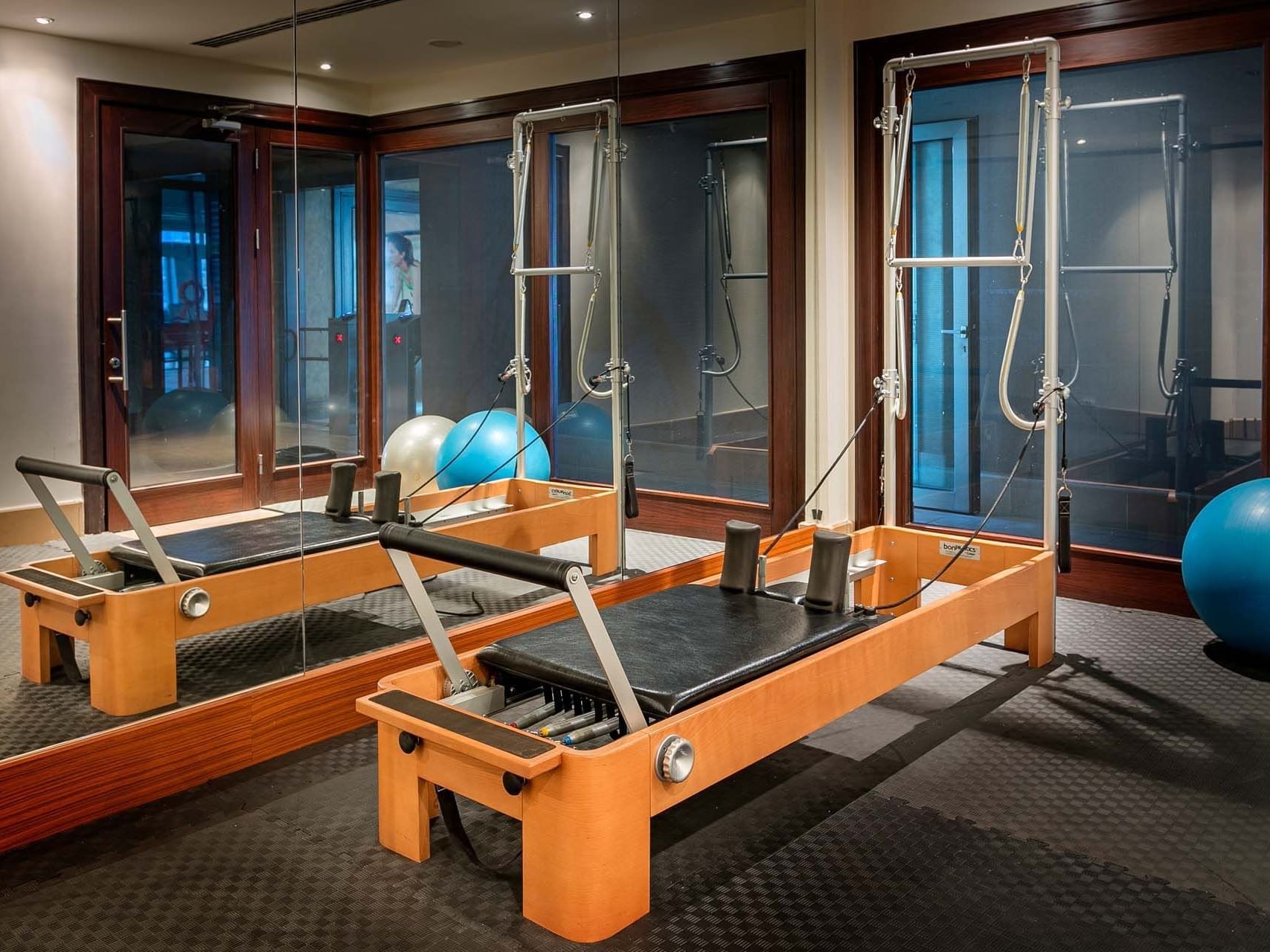 Pilates machines with balls and mirrors in the gym at Titanic Business Kartal.