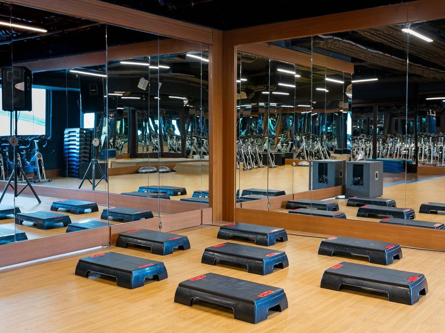 Fitness studio with workout equipment and large mirrors at Titanic Business Kartal.