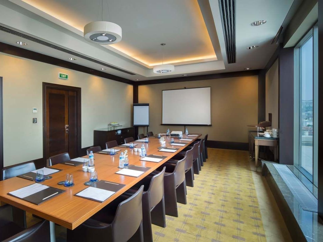 Long conference table with chairs in a modern meeting room at Titanic Business Kartal.