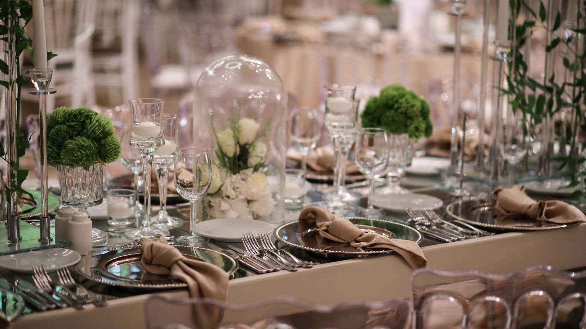Elaborately decorated table with floral arrangements and fine dining settings at Titanic Business Kartal in Istanbul.