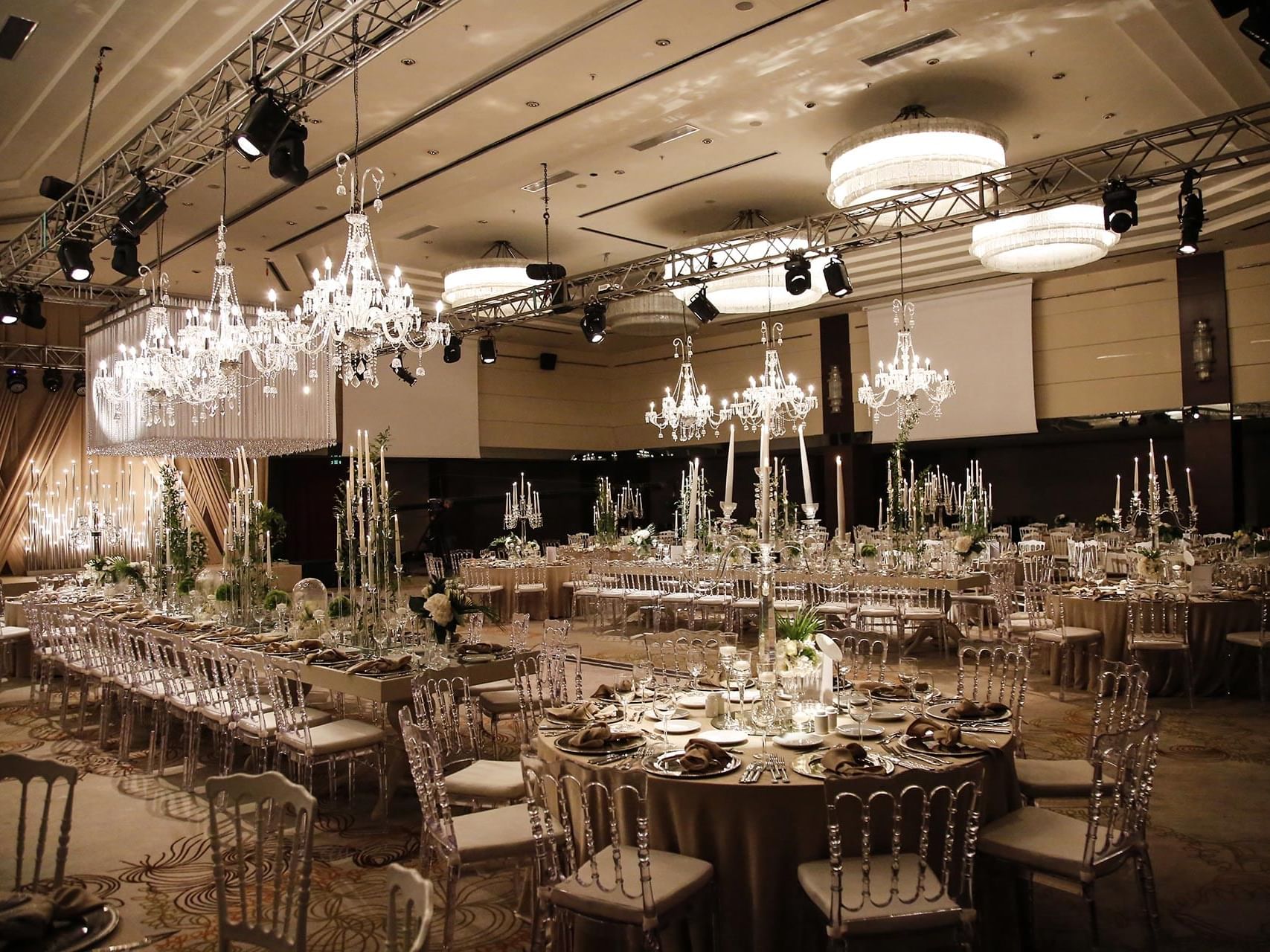 Banquets and long dining tables arranged with chairs in Karina Ballroom at Titanic Business Kartal