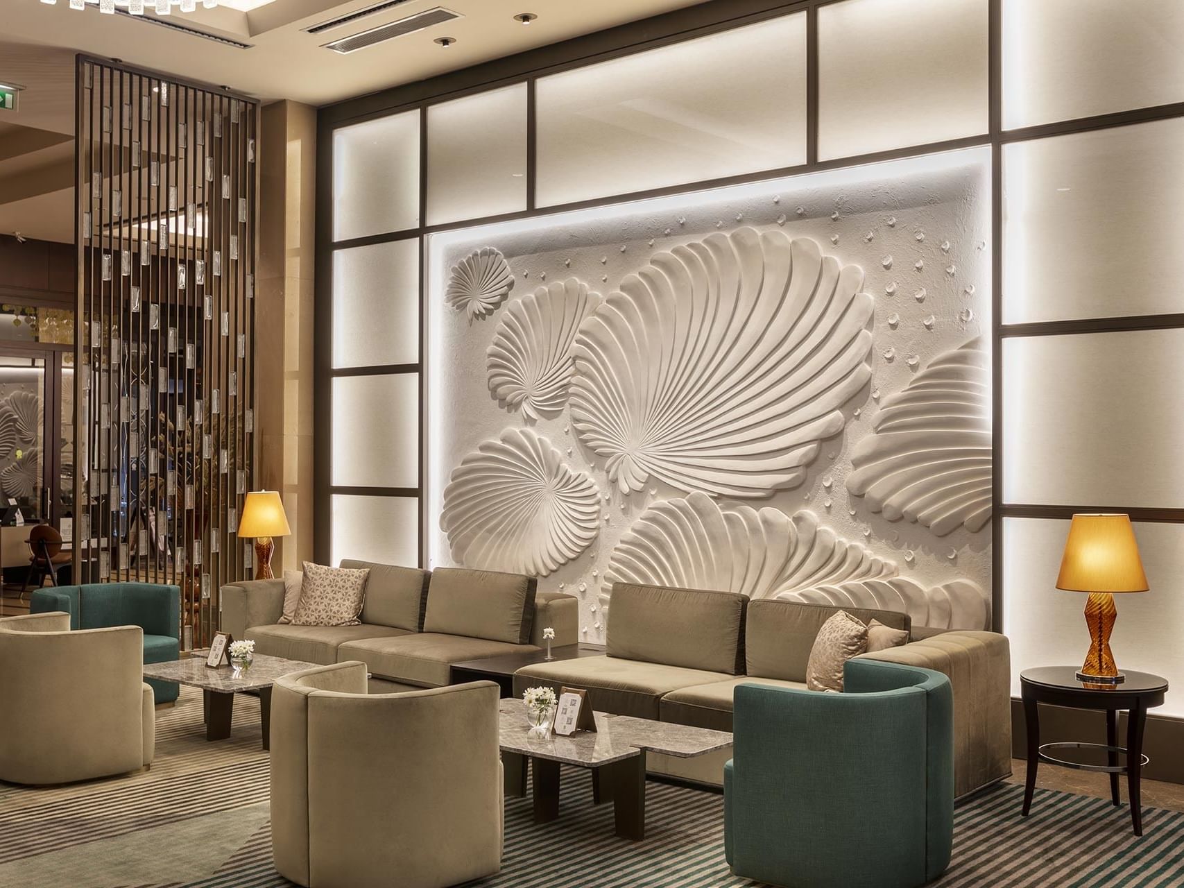 Elegant lobby with art deco wall and modern furniture at Titanic Business Kartal.