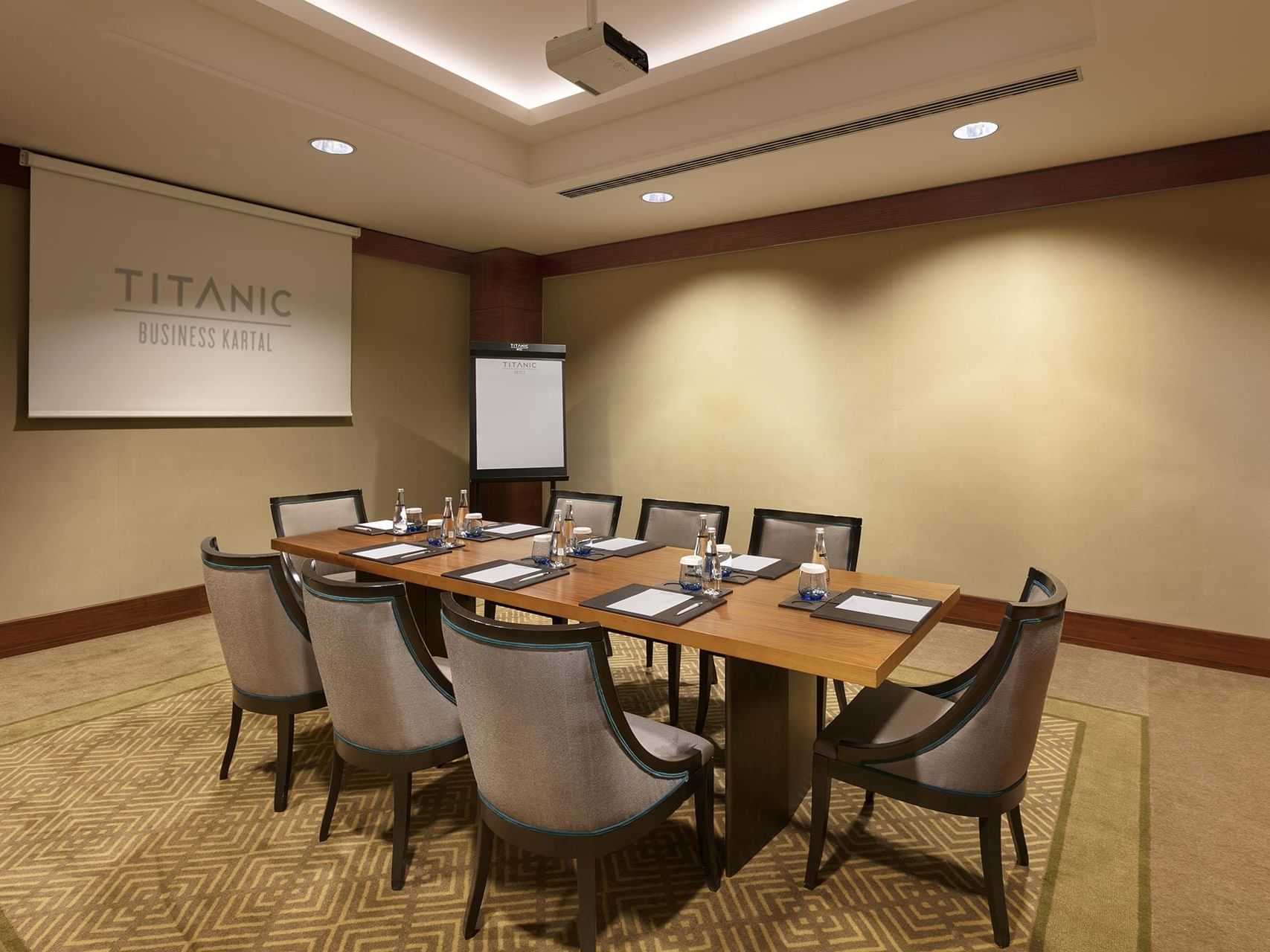 Boardroom table with chairs and a screen in Porto at Titanic Business Kartal